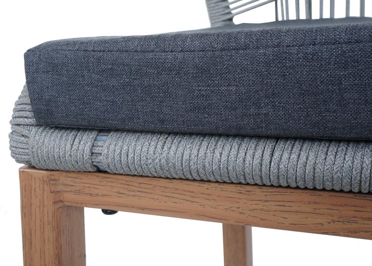 Detailansicht eines Stuhls mit Sitzkissen und geflochtener Rückenlehne