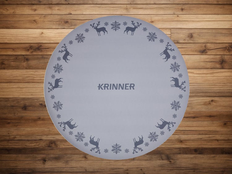 Runde Krinner Unterlegmatte für Christbaumständer mit Rentier- und Schneeflockenmotiven.