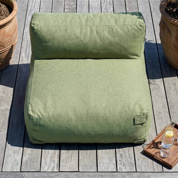 Grüner Outdoor-Sitzsack in Form eines Sessels auf einer Holzterrasse zwischen Tontöpfen.