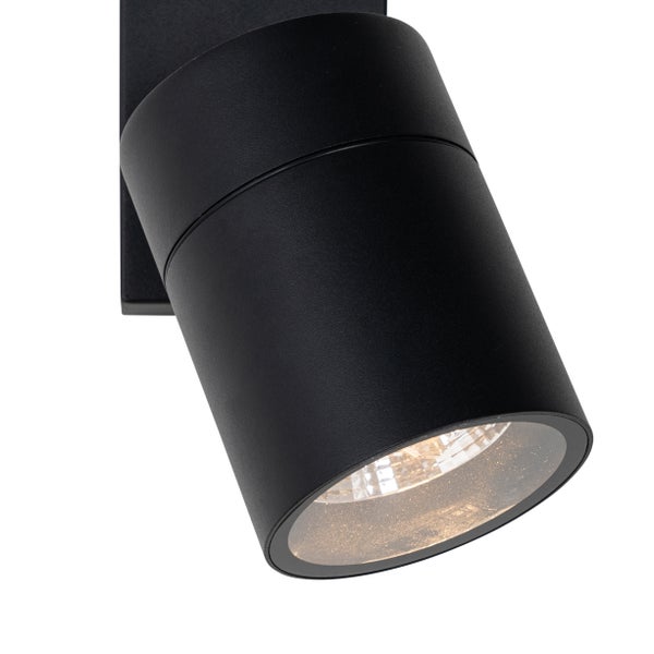 Zylindrische Außenwandleuchte in Schwarz mit schwenkbarem Strahler und Glasabdeckung.