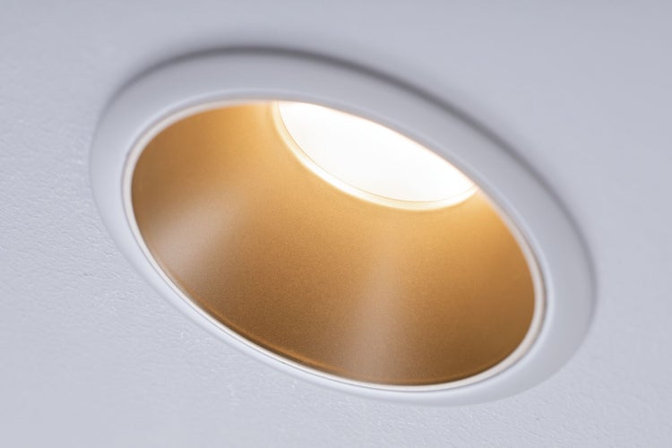 Runder LED-Einbaustrahler mit goldenem Reflektor und weißem Rahmen, montiert in einer Decke, eingeschaltet.