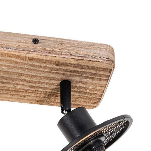 Detailaufnahme einer Deckenleuchte mit Holzsockel und schwarzem Metallspot