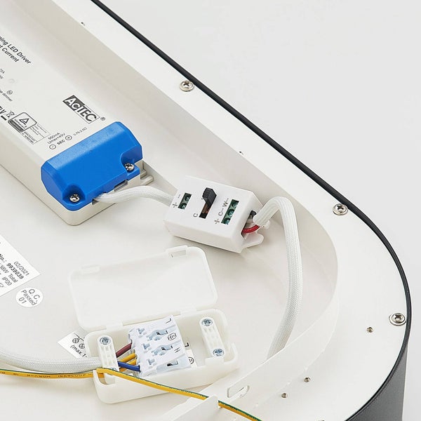 Detailansicht des Innenraums einer LED-Leuchte mit sicherheitsgeprüftem LED-Treiber, AcTEC Logo, Anschlussklemme und Farbtemperaturschalter.