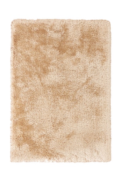 Rechteckiger Hochflor-Teppich in Beige mit weicher, zotteliger Oberfläche.