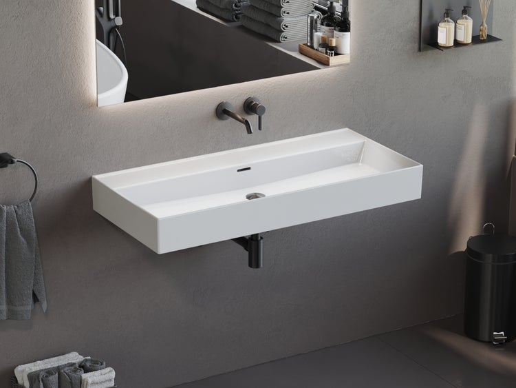 Wandhängendes rechteckiges Waschbecken in Weiß mit schwarzer Unterputz Armatur in einem modern gestalteten Badezimmer mit grauen Wänden.
