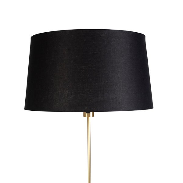 Stehlampe mit schwarzem Lampenschirm und goldenem Ständer