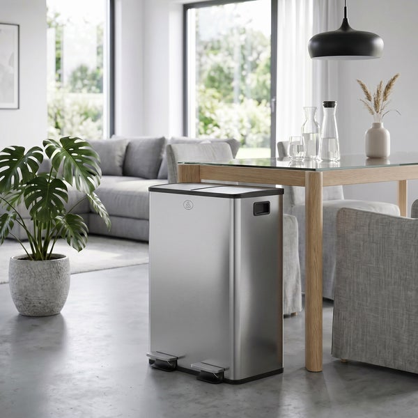 Rechteckiger Mülltrenner aus Metall mit zwei Pedalöffnungen, platziert in einem modernen Wohnraum mit Essbereich.