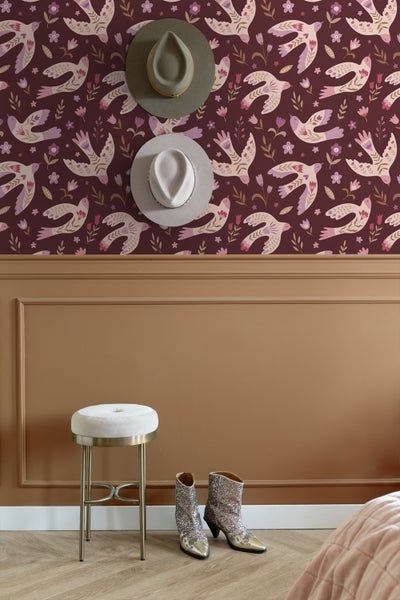 Szene mit gemusterter Tapete, Hocker, Hüten und Stiefeln