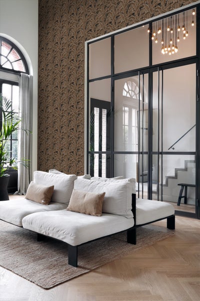 Wohnzimmer mit gemusterter Tapete, Sofa und Glastür