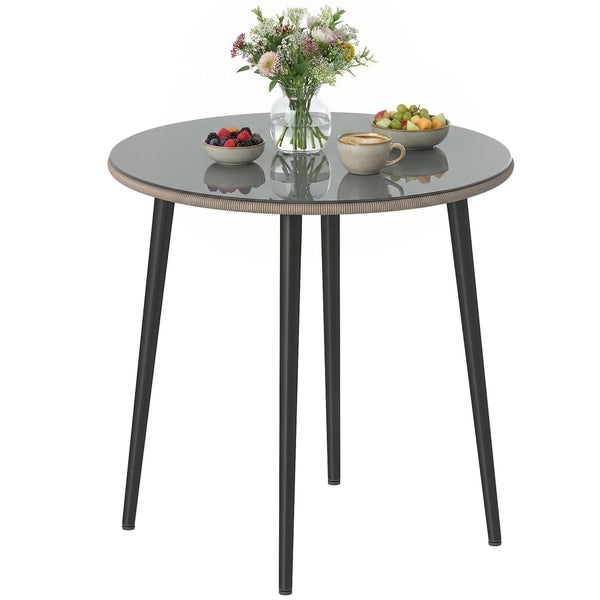 Runder Bistrotisch mit Glasplatte, geflochtenem Rand und vier dunklen Metallbeinen.