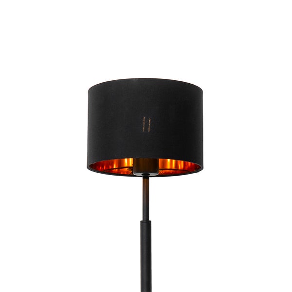 Zylindrischer schwarzer Lampenschirm mit goldener Innenseite und schwarzem Lampenfuß.