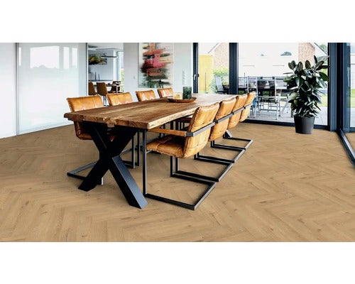 Esszimmer mit großem Holztisch, Lederstühlen und verlegtem Laminatboden im Fischgrätmuster.