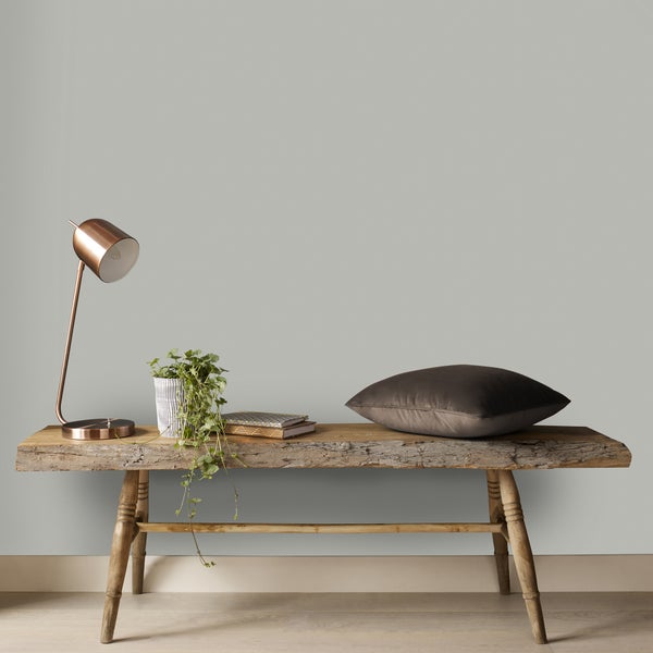 Holzbank mit Lampe, Pflanze, Büchern und Kissen