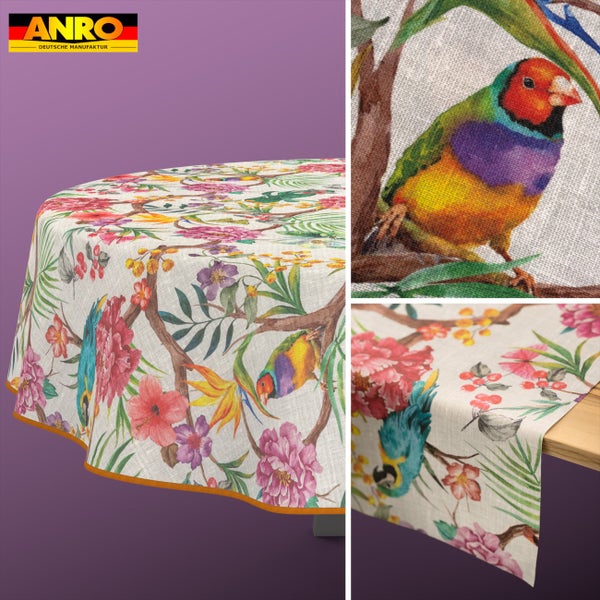 Runde Tischdecke und Tischläufer mit Motiven von exotischen Vögeln und tropischen Blumen auf strukturiertem Stoff. ANRO Logo.