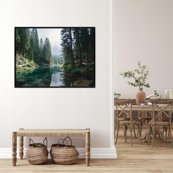 Großes gerahmtes Wandbild mit Wald- und Bergseelandschaft in einem hellen Wohnraum mit Holzbank und geflochtenen Körben.