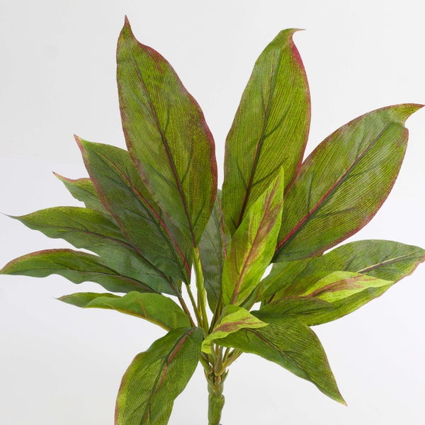 Künstliche Pflanze mit grünen, rot geäderten Blättern am Stiel für die Innendekoration.