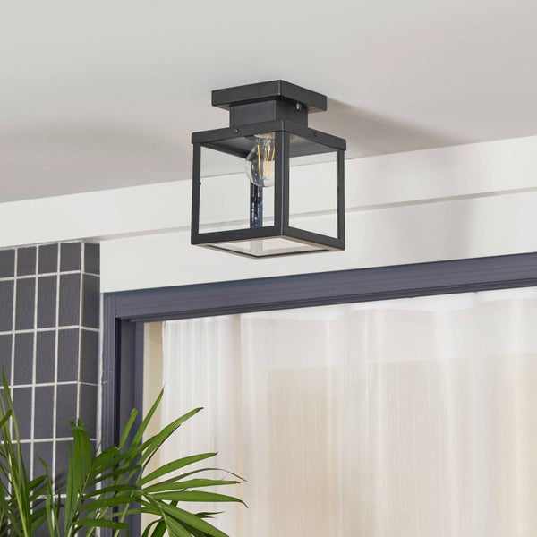 Schwarze Deckenleuchte im Laternen-Stil aus Metall und Glas mit sichtbarem Leuchtmittel.