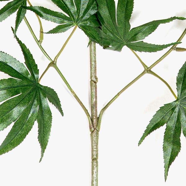 Künstlicher Zweig eines Japanischen Ahorns mit grünen fächerförmigen Blättern.