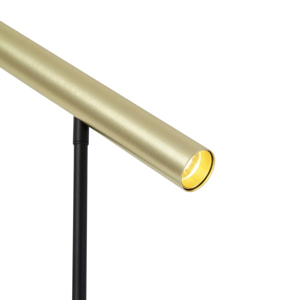 Detail einer LED-Lampe mit zylindrischem Metallkopf in Messing-Optik an einem schwarzen Stab.