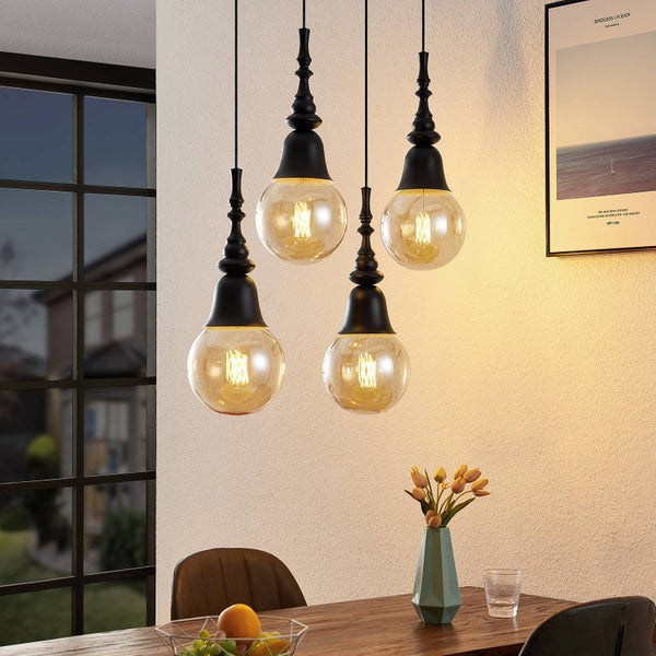 Vierflammige Pendelleuchte mit Kugelglaslampenschirmen über Esstisch