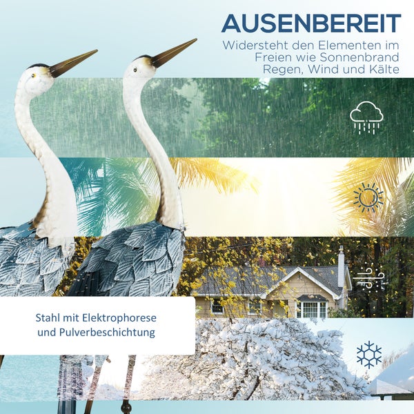 Zwei dekorative Reiherfiguren aus Metall im Garten.