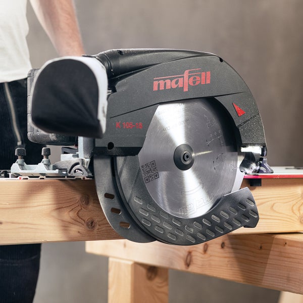 Mafell Handkreissäge K 105-18 auf einem Holzbalken positioniert für präzise Sägearbeiten.