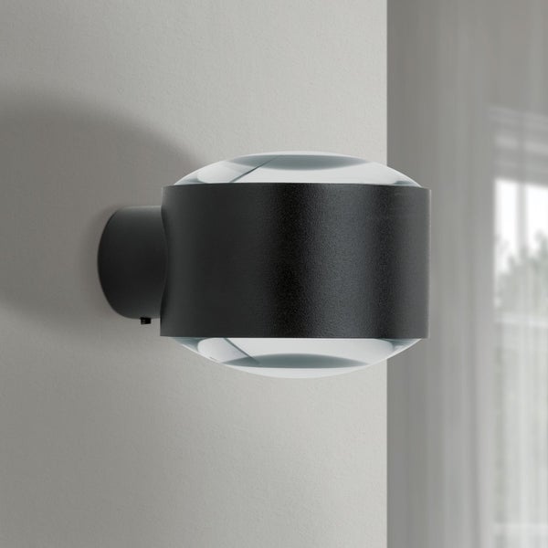 Moderne schwarze Wandleuchte aus Metall mit zylinderförmigem Gehäuse und zwei gewölbten Glaslinsen für Up- und Downlight-Beleuchtung.