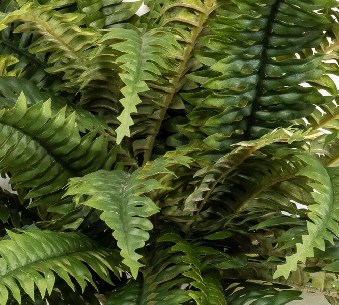 Nahaufnahme einer künstlichen Sonnenblume mit einem strukturierten grünen Blatt und gelben Blütenblättern am Stiel.