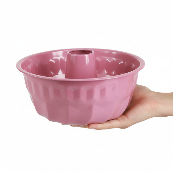 Rosa Gugelhupfform aus Metall, von einer Hand gehalten.