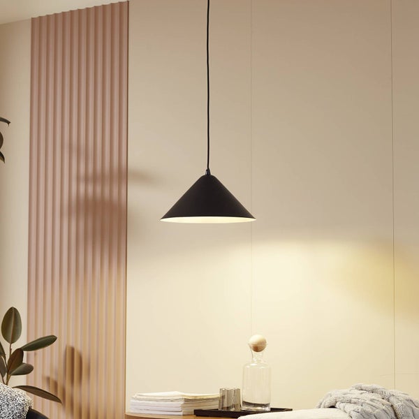 Schwarze, konische Pendelleuchte in einem hellen, modern eingerichteten Raum mit Holzlamellenwand und minimalistischer Dekoration.