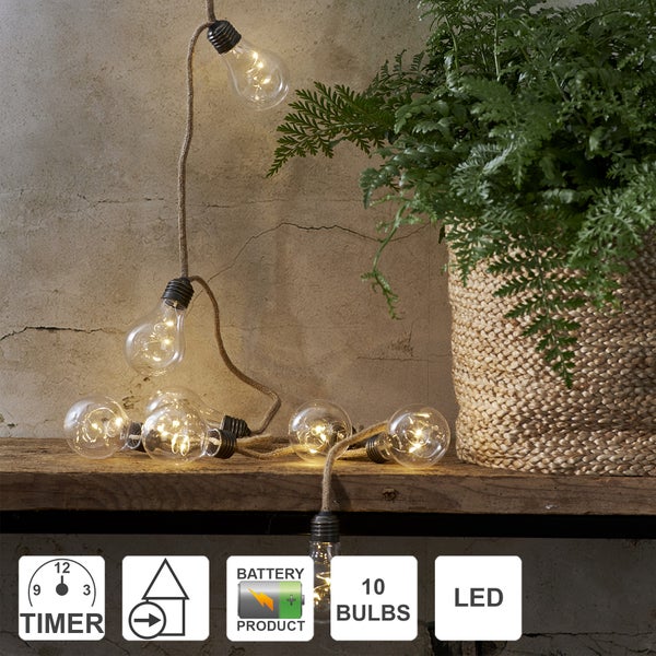 Dekorative LED-Lichterkette mit zehn Glühbirnen, Timer und Batteriebetrieb neben Zimmerpflanze
