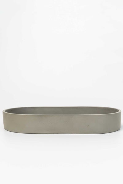 Ovale Pflanzschale aus grauem Beton.