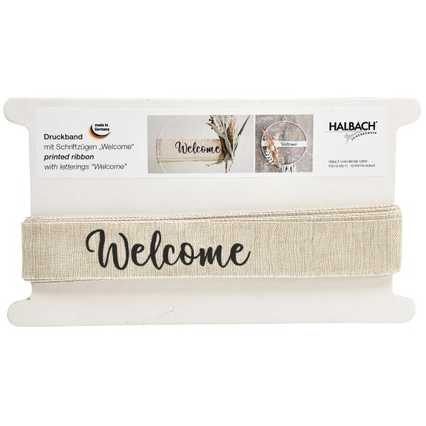 Bedrucktes Band mit der Aufschrift Willkommen auf einer Spule