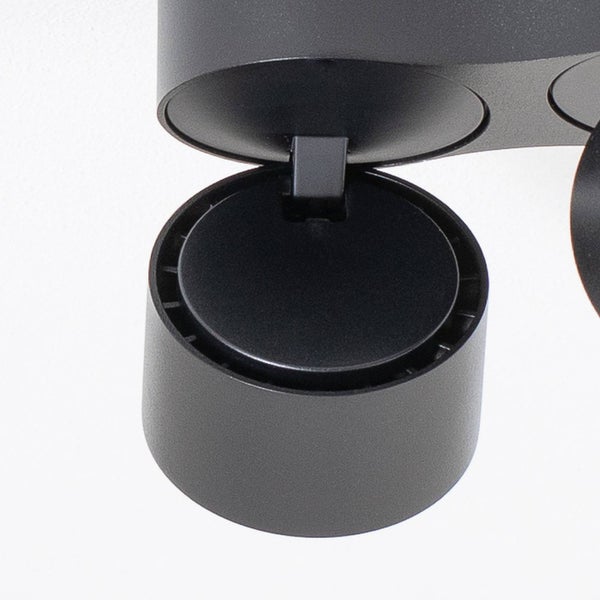 Nahaufnahme eines verstellbaren zylindrischen Spotstrahlers aus schwarzem, mattem Metall mit Gelenk.