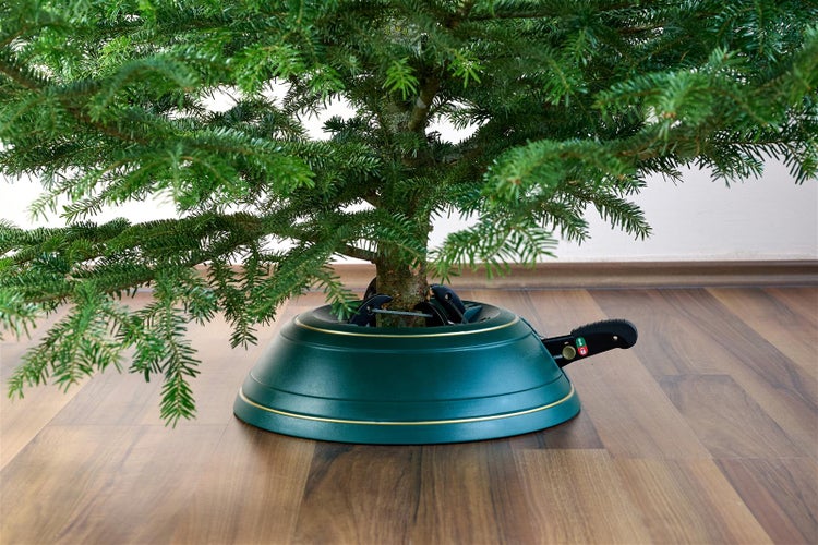 Weihnachtsbaum im Weihnachtsbaumständer auf Holzboden