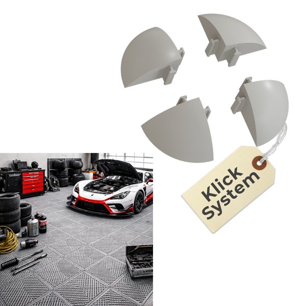 Vier graue Eckstücke für Kunststoff-Bodenfliesen mit Klicksystem und eine Werkstatt mit Sportwagen auf verlegtem Garagenboden.
