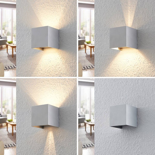 Silberne würfelförmige Wandleuchte aus Metall mit verstellbarem Lichtstrahl nach oben und unten in vier verschiedenen Einstellungen.