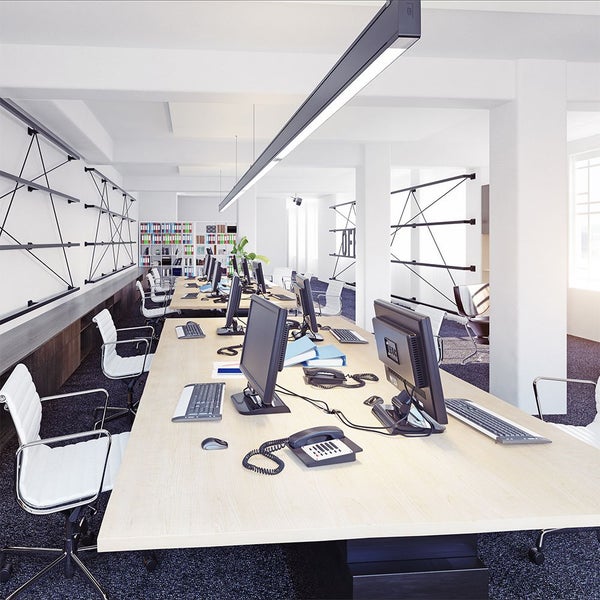 Helles Büro mit Computern, Schreibtischen und Regalen