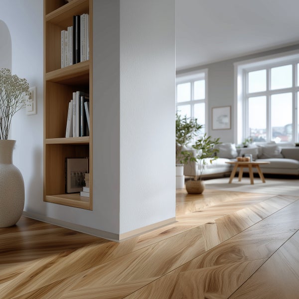 Heller Wohnraum mit Bücherregal, Dekoration und Fischgrätparkett