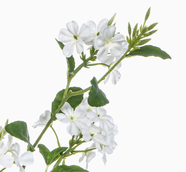 Künstlicher Zweig mit weißen Blüten und grünen Blättern.