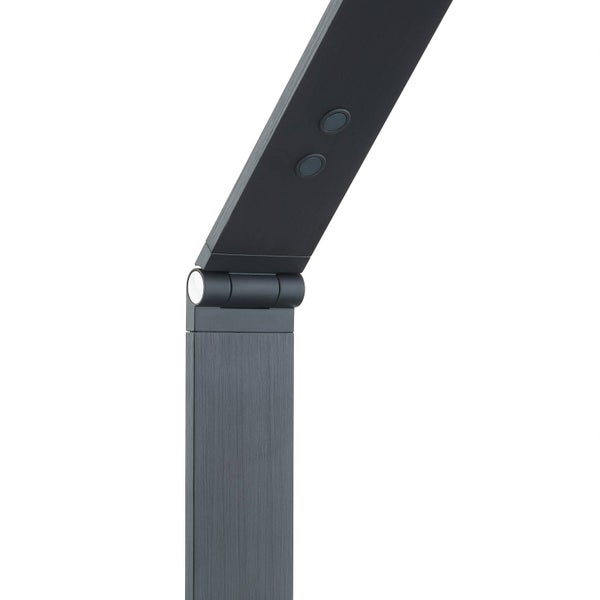 Gelenk einer Schreibtischlampe aus gebürstetem Metall mit zwei runden Bedienelementen.