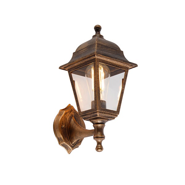 Antike Außenwandleuchte in Laternenform aus Metall mit Glaseinsätzen und sichtbarem Leuchtmittel.