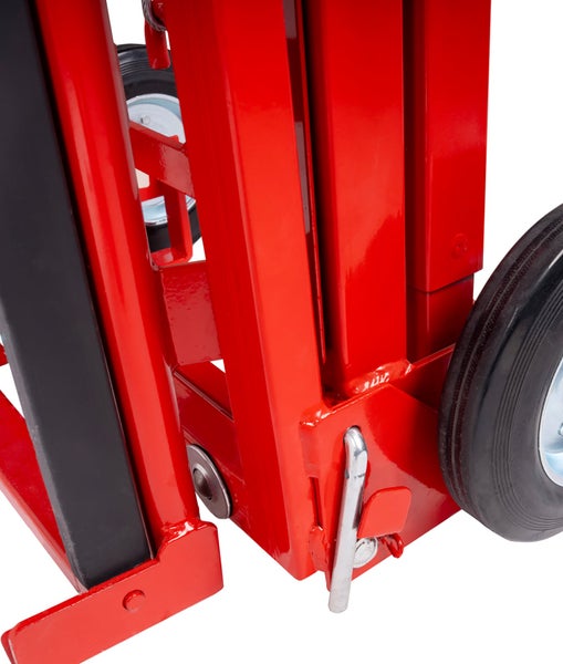 Detailansicht eines roten Metallrahmens eines Transportgeräts mit Rädern und Sicherungsbolzen.