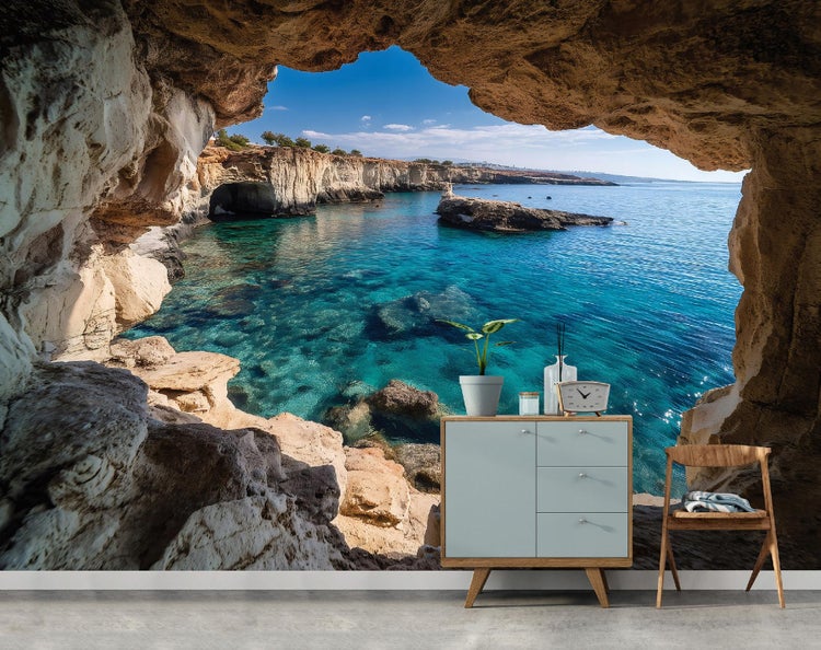 Wandbild mit Höhlenblick auf klares blaues Meer