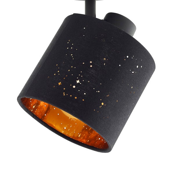 Zylindrischer Strahler-Lampenschirm aus schwarzem Stoff mit Sternenmuster-Lochung und goldfarbener Innenseite.