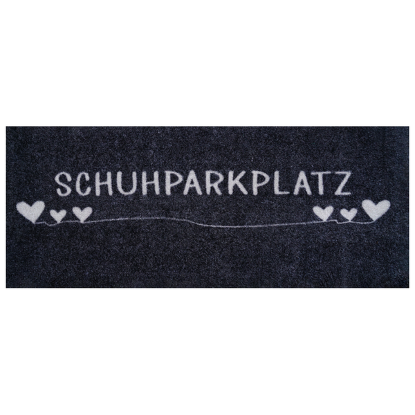 Anthrazitfarbene Fußmatte mit der Aufschrift SCHUHPARKPLATZ und weißen Herzen.
