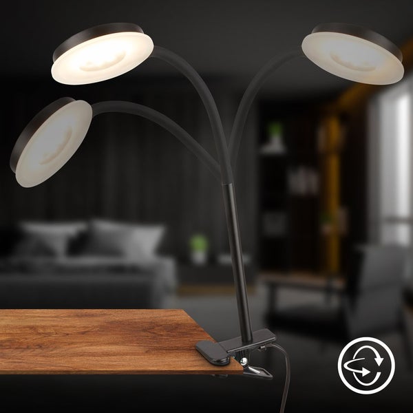 Schwarze LED Klemmlampe mit drei flexiblen Armen und runden Köpfen, befestigt an einer Holzplatte. Symbol für drehbare Ausrichtung.