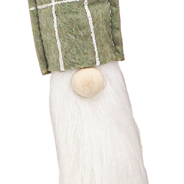 Detailaufnahme eines dekorativen Wichtels mit karierter Mütze, Bart und hölzerner Nase.