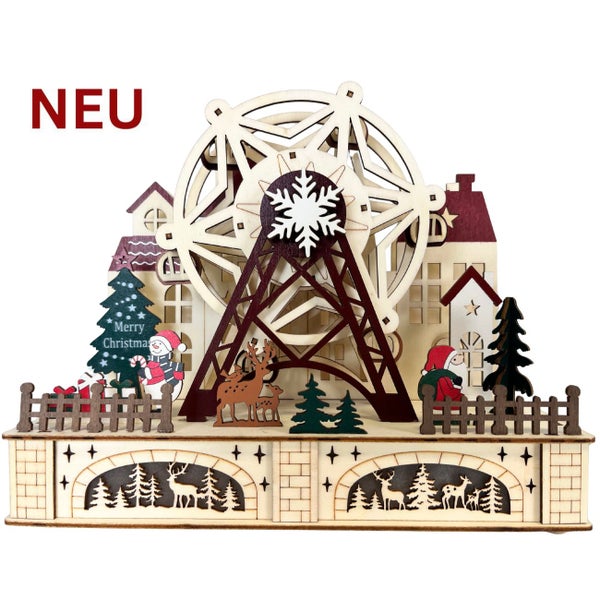 Dekorative hölzerne Weihnachtslandschaft mit Riesenrad, Tannenbäumen, Schneemann und Weihnachtsmann in einer kleinen Stadtkulisse.