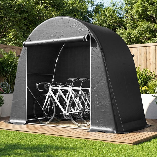 Fahrradgarage in Zeltform aus dunklem Material mit zwei weißen Fahrrädern im Inneren auf einer Holzterrasse im Garten.